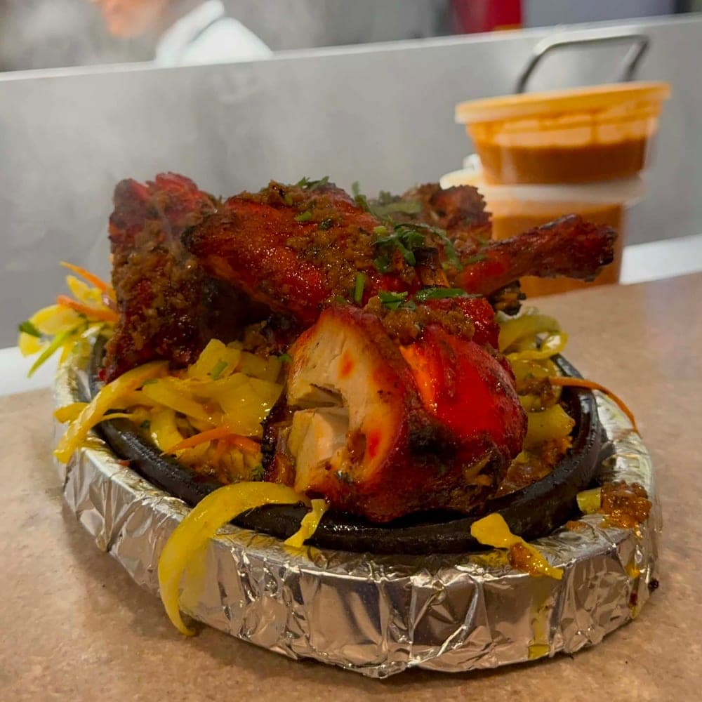 Tandoori chicken on a sizzler plate
